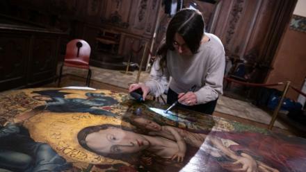 Une experte travaille à la restauration de "La Vierge au buisson de roses" peinte en 1473 par Martin Schongauer, le 5 mars 2026 dans l'église des Dominicains à Colmar, dans le Haut-Rhin