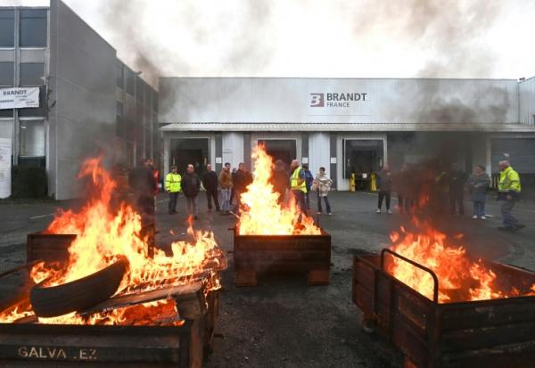 Des palettes brûlées devant l'usine Brandt où sont rassemblés des employés, le 11 décembre 2025 à Vendôme, dans le Loir-et-Cher