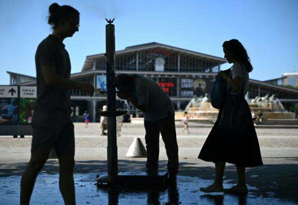 Des personnes se rafraîchissent à une fontaine publique près de la Grande Halle de La Villette alors qu'une vague de chaleur frappe le sud de l'Europe, à Paris, le 29 juin 2025