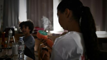 Une enfant se rafraîchit dans une salle de classe en école élémentaire, à Bordeaux dans le sud-ouest de la France, le 1er juillet 2025