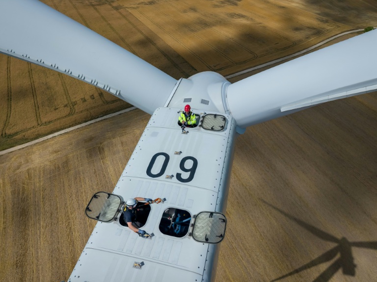 Vue aérienne d'un mineur (en haut) participant à une formation à l'exploitation d'éoliennes avec un instructeur (en bas), au parc éolien de Gorzyca, dans l'ouest de la Pologne, le 8 juillet 2026