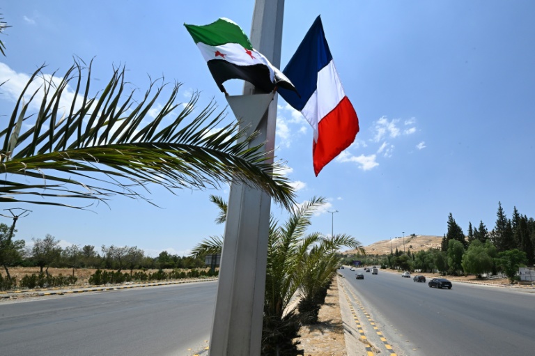 Des drapeaux français et syrien le long de la route menant à l'aéroport de Damas, le 6 juillet 2026, en amont d'une visite du président français Emmanuel Macron en Syrie