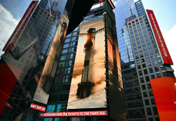 Images géantes de fusées SpaceX sur les murs d'immeubles de Times Square, à New York, non loin de celui du Nasdaq, le jour de l'entrée en Bourse, le 12 juin 2026. 