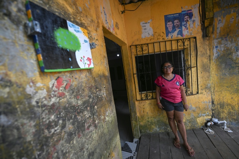La retraitée Elizabeth Campos Serra devant sa maison de Vila da Barca, un quartier pauvre bâti sur pilotis sur les rives du fleuve Guama à Belem, dans l'État du Para, le 5 novembre 2025 au Brésil