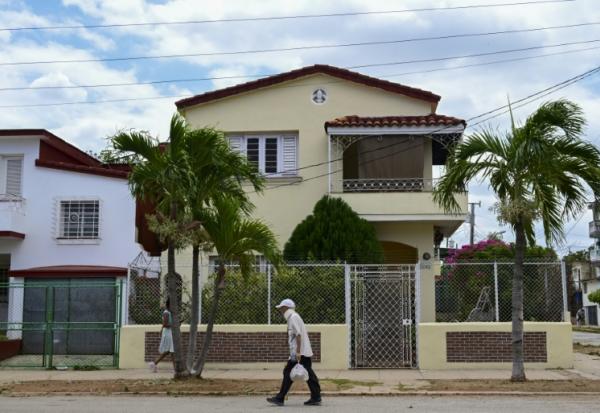 Un passant marche devant une maison dans un quartier cossu de La Havane, le 23 avril 2026
