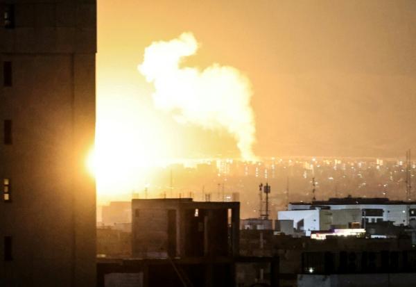 De la fumée et des flammes au-dessus du site de frappes aériennes sur un quartier du centre de Téhéran, le 6 mars 2026 en Iran