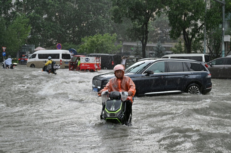 Torrential rain and flooding killed six people and forced at least 130,000 to evacuate in China's Guangxi region