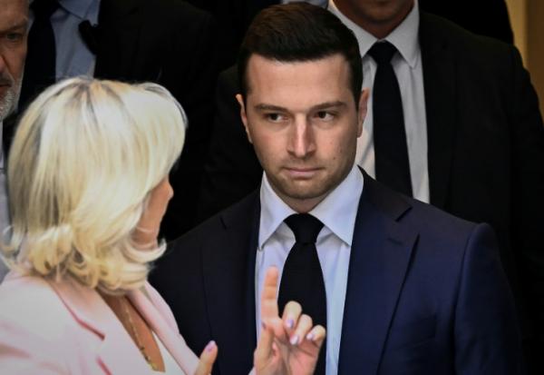 Jordan Bardella (d), président du Rassemblement national (RN), et Marine Le Pen (g), quittent le nouveau siège du parti à l'issue d'une réunion, après que la cour d'appel de Paris a rendu son verdict dans le procès pour détournement de fonds publics européens, le 7 juillet 2026 à Paris