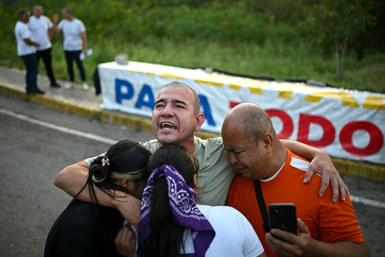 Le prisonnier vénézuélien Richard Puentes (C) enlace des membres de sa famille après sa libération de la prison El Rodeo 1, à Guatire, dans l’État de Miranda, au Venezuela, le 23 février 2026