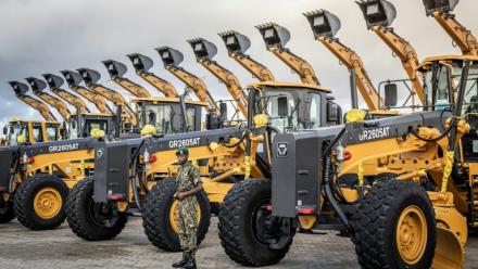 Un membre du Service national de la jeunesse (NYS) du Kenya surveille des excavatrices et autres engins lourds avant une cérémonie de pose de la première pierre d'une mégaraffinerie pétrolière au port de Lamu (Kenya), le 30 septembre 2026