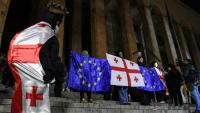 Des manifestants brandissent les drapeaux de la Géorgie et de l'Union européenne lors de la vague de contestation qui a suivi les élections législatives de 2024, le 5 décembre 2024 à Tbilissi