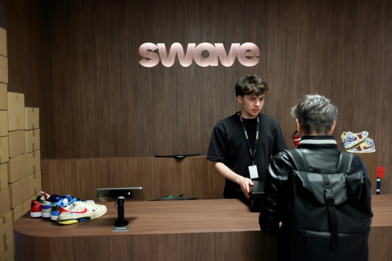 Un client récupère les chaussures qu'il a achetées lors d'une vente aux enchères en direct sur l'application Whatnot, au magasin Swave à Paris, le 12 mars 2026