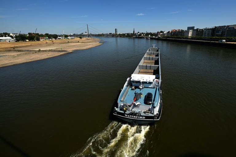 Un bateau navigue sur le Rhin en partie asséché à Düsseldorf, le 28 juillet 2026
