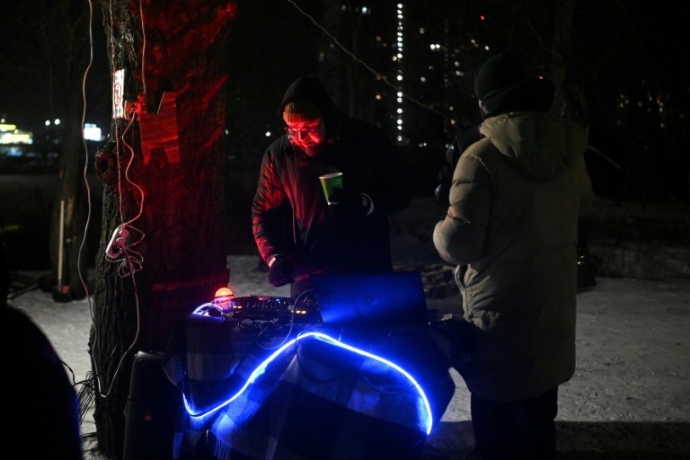 Un DJ anime une fête improvisée par des habitants dans le froid polaire à Kiev, le 18 janvier 2026