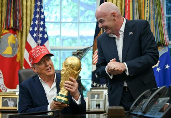 Le président américain Donald Trump et le président de la Fifa Gianni Infantino, avec le trophée de la Coupe du monde dans le bureau ovale de la Maison Blanche, le 22 août 2025 à Washington,