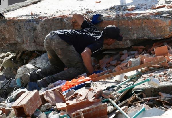 Un homme cherche des survivants à Pereira, en Colombie, le 11 août 2026