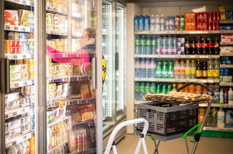 Une employée de la société Api remplit les rayons d'une superette en libre-service sans caissier à Claix, le 1er décembre 2022 en Charente