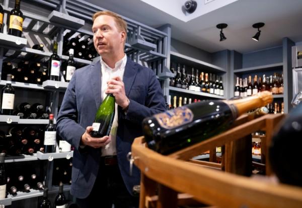 Michael Warner, cofondateur et directeur de DCanter, dans une boutique de vins affectés par les tarifs douaniers à Washington, le 19 août 2025