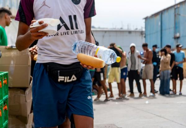 Des bénévoles de l'ONG Luna Blanca distribuent de la nourriture à des migrants sur le site industriel d'El Tajaral à Ceutae, Espagne, le 2 septembre 2026