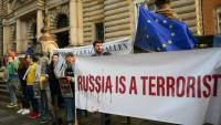 Des manifestants protestent avec des banderoles "la Russie est un terroriste" devant le tribunal où est jugé un ancien officien ukrainien à Hambourg (nord de l'Allemagne), le 14 octobre 2026