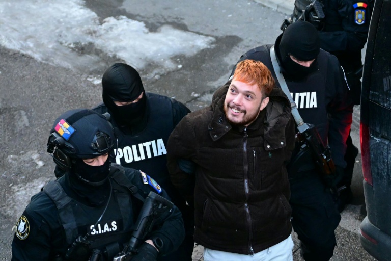 Le narcotrafiquant Mohamed Amra escorté par des policiers roumains le 23 février 2025 à Bucarest